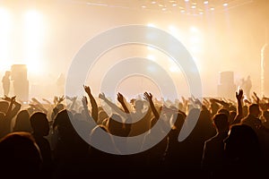 Silhouette of people with raised hands on concer. Crowd on music show