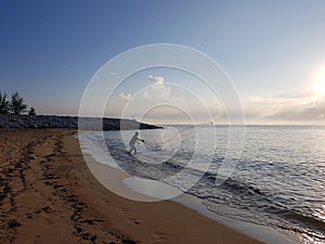 Silhouette people throw a fishing net into the sea