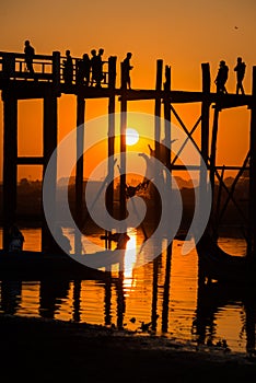 Silhouette of people on U Bein bridge at sunset in Amarapura. Mandalay, Myanmar