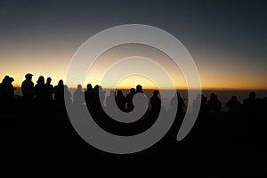 The silhouette of the people waiting to watch the sunrise in the morning at the viewpoint on the hill