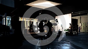 Silhouette of people working in big production studio