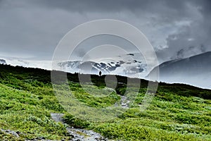 Silhouette of a person in front of VatnajÃ¶kull glacier in dramatic light, Iceland