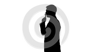 Silhouette of person showing gesture of silence, censorship, confidential data