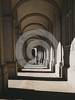 Silhouette of the person under arcades