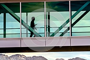 Silhouette of a person walking inside a building