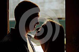 Silhouette photo. black faces.Close-up of kissing and embracing couples in old, doorway, family. date, attraction