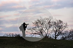 A silhouette photographer action during sunrise