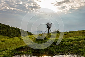 Silhouette photographer action during sunrise