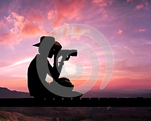 Silhouette of photographer on bridge