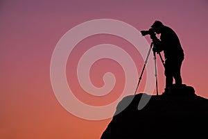 Silhouette Photographer on hill at twilight