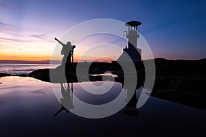 Silhouette Photographer With Lighthouse