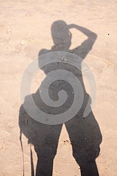 Silhouette photographer on sand beach