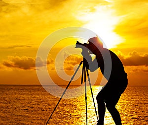 Silhouette photographer at sunset