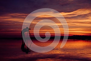 Silhouette Photographer take photo beautiful seascape at sunset