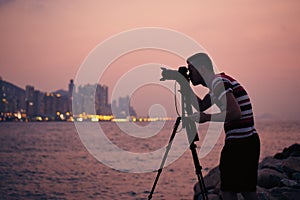 Silhouette of photographer with tripod