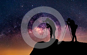 Silhouette of a photographer who shooting a milky way