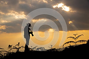 Silhouette of a photographer who shoots a sunset