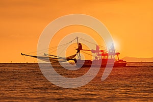 Silhouette photography of fishery boat and sunset sky over sea h