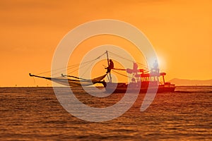 Silhouette photography of fishery boat and sunset sky over sea h photo