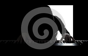 Silhouette of a pianist on a black and white background, the gloomy figure of a musician in the backlight