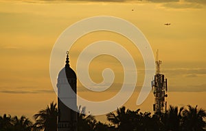 Silhouette picture of Masque in Golden Sky - Sunset - Evening Sun in full orange color