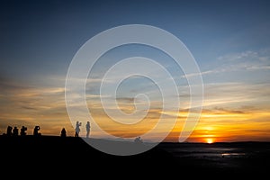 Silhouette picture of tourists taking photos with the rising sun,people watch the first light and the morning mist,sunrise in the