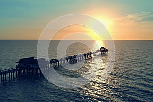 Silhouette of a pier over the water at sunset