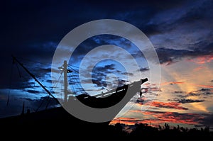 Silhouette of pinisi ship with sunset sky