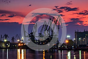 The silhouette of port cranes, at stunning twilight