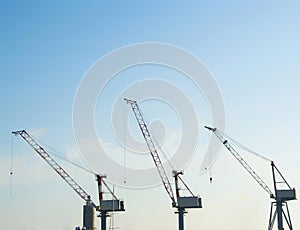 Silhouette of portal cranes in harbor