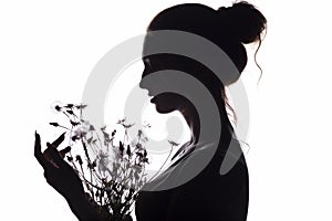 Silhouette of girl with a bouquet of with dandelions, young woman face on a white isolated background