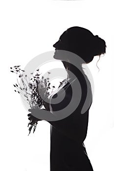 Silhouette portrait of a beautiful girl with a bouquet of with dandelions on a white isolated background