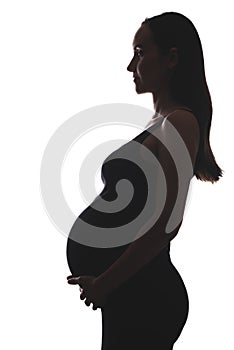 Silhouette portrait of pregnant woman on white background with hands on belly, vertical image, pregnancy concept