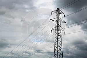 Silhouette of a power cable tower on cloudy day