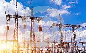 Silhouette of power plant and transformer substation batteries, the beautiful sky with the sun at sunset