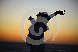 Silhouette of a Pregnant woman at the beach