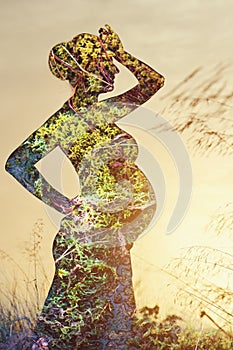 Silhouette of pregnant woman combined with natu