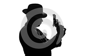 Silhouette of private detective with a gun in right hand. Agent stay side to camera and looks like mafioso Al Capone. Criminal