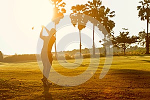 Silhouette Professional Golfer asian man swing and hitting golf ball practice at golf driving range and fairway in sunny morning d