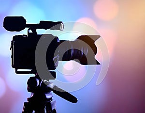 Silhouette of a professional studio video camera. Preparation and release of news