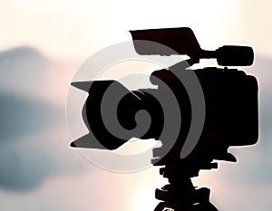 Silhouette of a professional studio video camera. Preparation and release of news