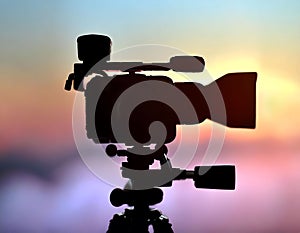 Silhouette of a professional studio video camera. Preparation and release of news