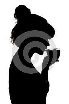 Silhouette profile of a beautiful woman drinking hot black tea from a glass transparent cup, an unrecognizable girl face on white