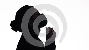 Silhouette profile of young woman thinking in protective mask on white studio background, figure of pensive girl, concept health