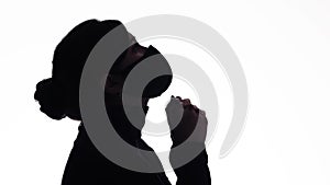 Silhouette profile of young woman thinking in protective mask on white studio background, figure of pensive girl, concept health