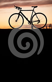 Silhouette of race bike in sunset photo