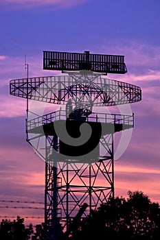 Silhouette radar tower plane and twilight sky