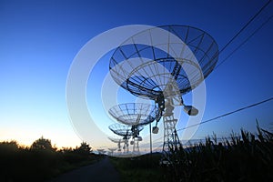 The silhouette of a radio telescope