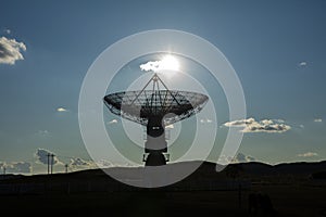 The silhouette of a radio telescope