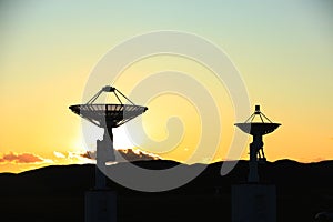 The silhouette of a radio telescope